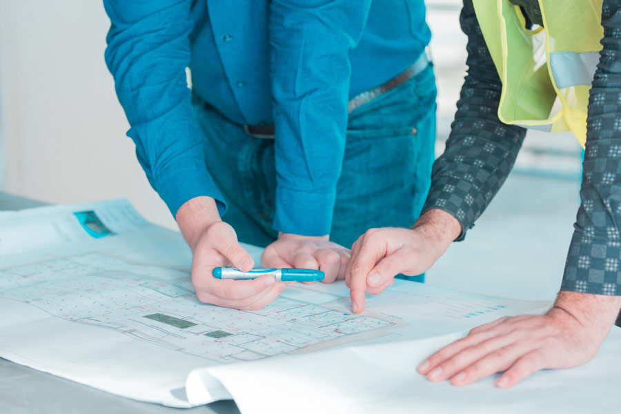 one-worker-showing-important-details-architectural-plan-project-another